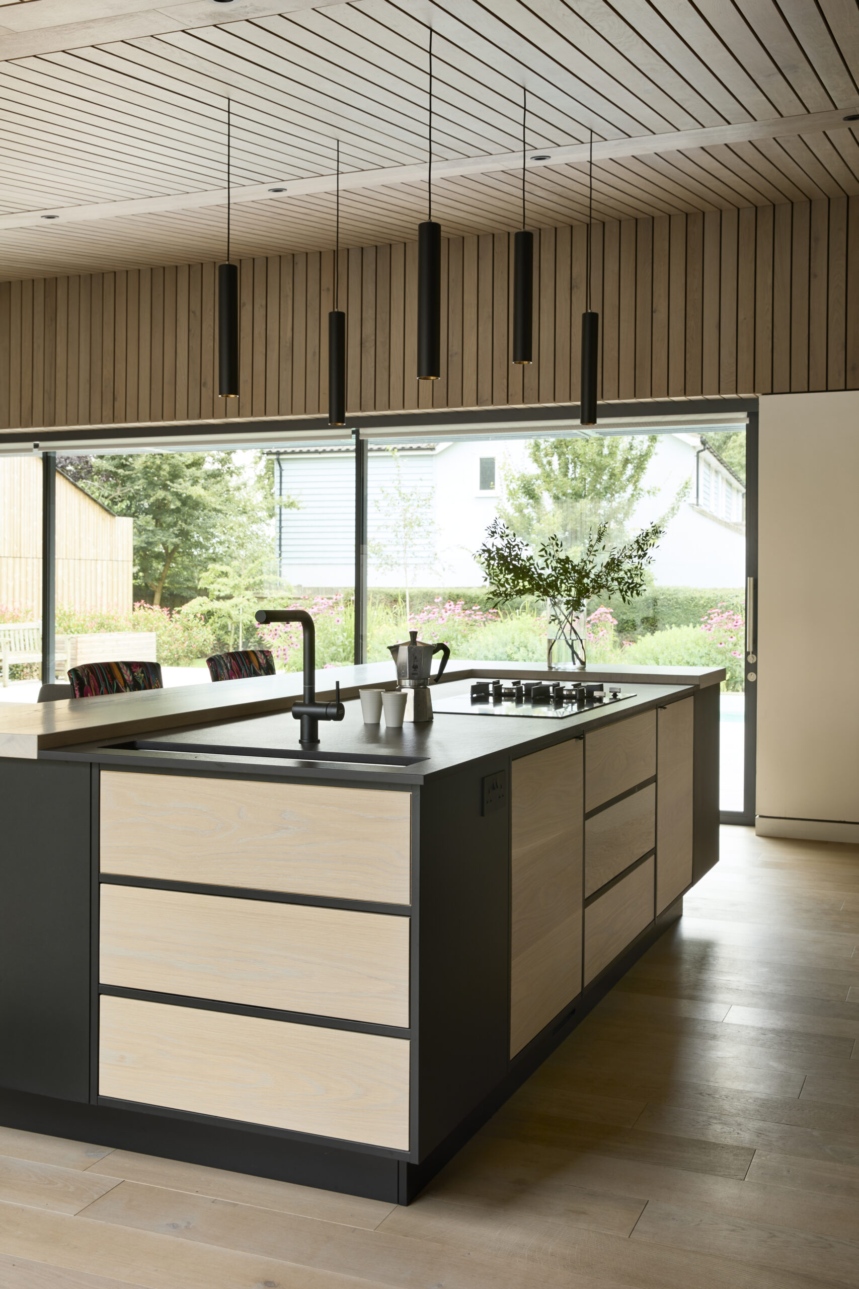 Contemporary kitchen with integrated living space and sophisticated lighting