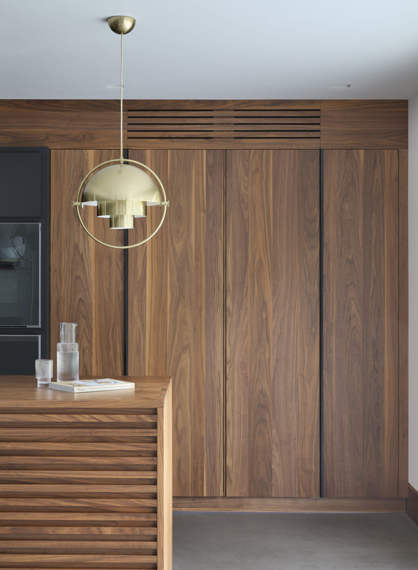 A detailed close-up of a custom cabinet handle and fine joinery.
