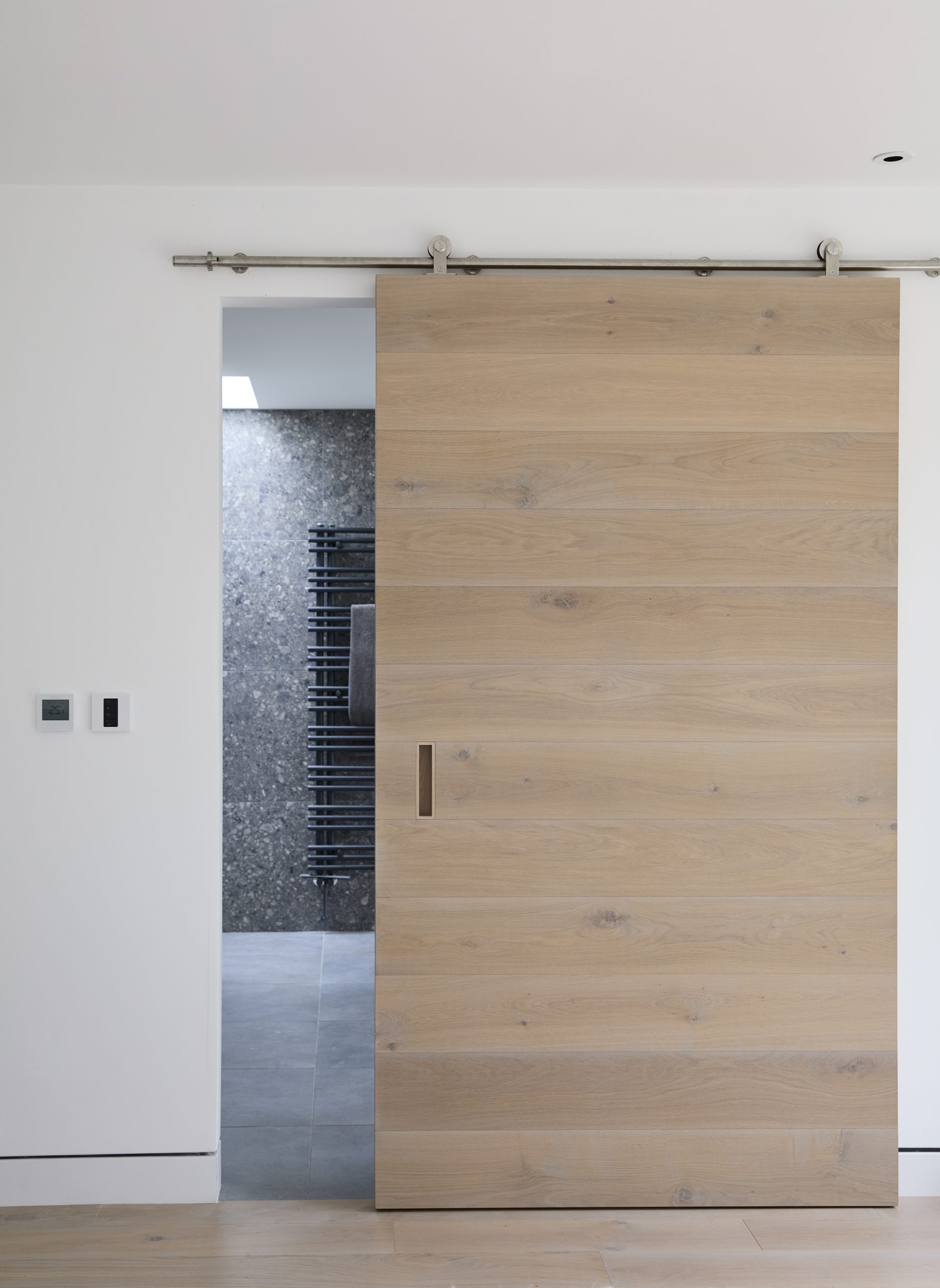 Bespoke bathroom furniture featuring a custom vanity unit and elegant storage