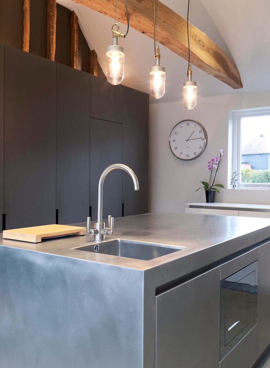 A sleek stainless steel worktop integrated into a modern bespoke kitchen